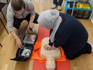 A woman parcticing CPR